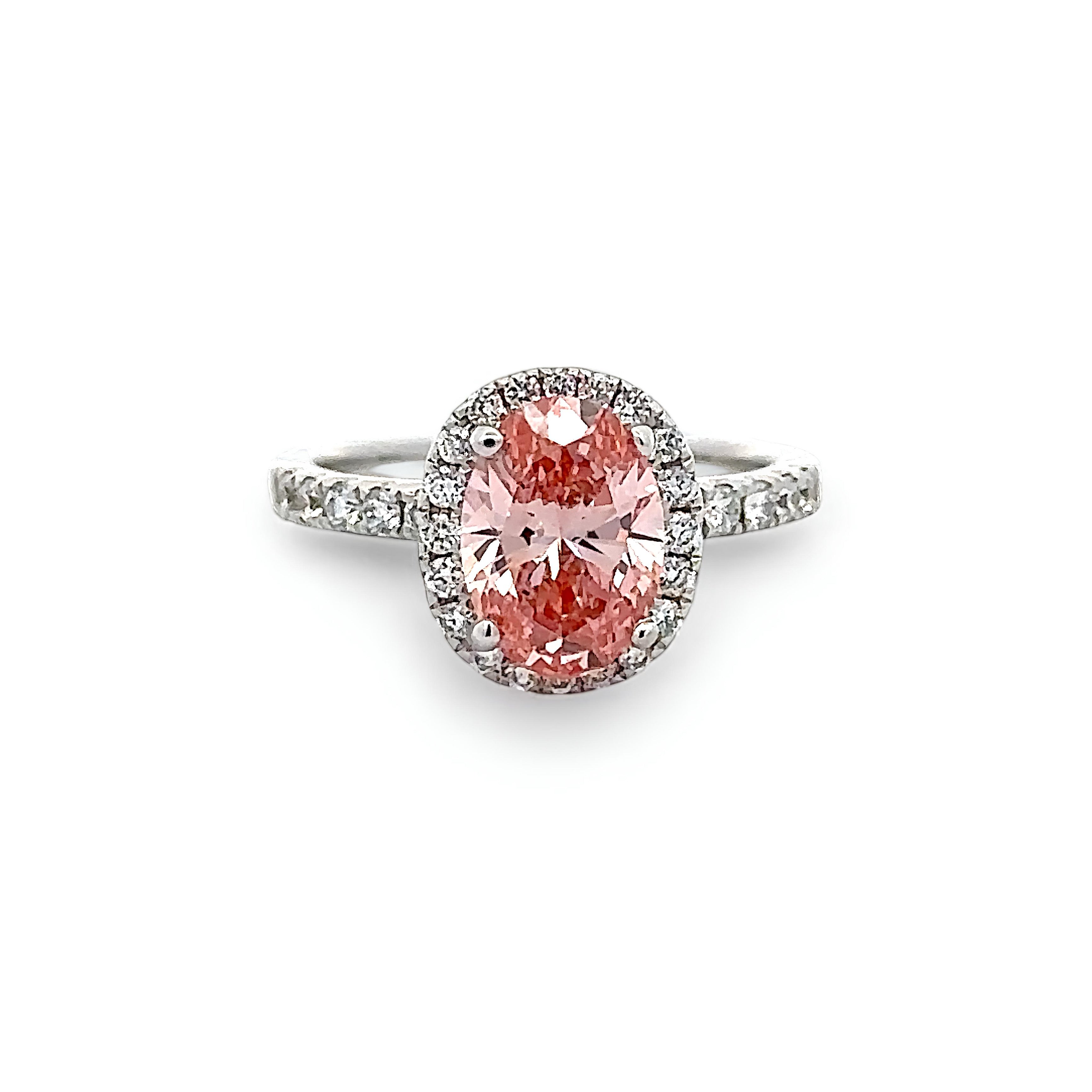 18K PINK DIAMOND OVAL CUT CENTRE STONE IN A HALO SETTING IN A 18K DIAMOND ACCENTED BAND – 2.55 CTW