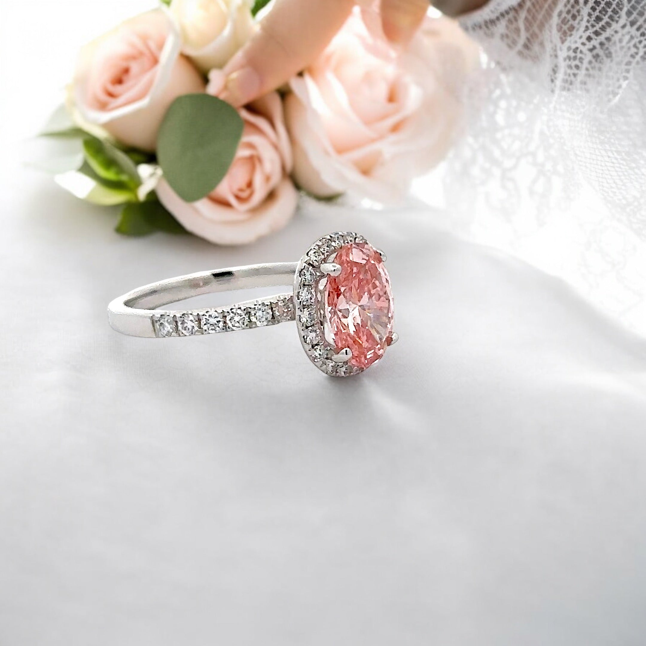 18K PINK DIAMOND OVAL CUT CENTRE STONE IN A HALO SETTING IN A 18K DIAMOND ACCENTED BAND – 2.55 CTW