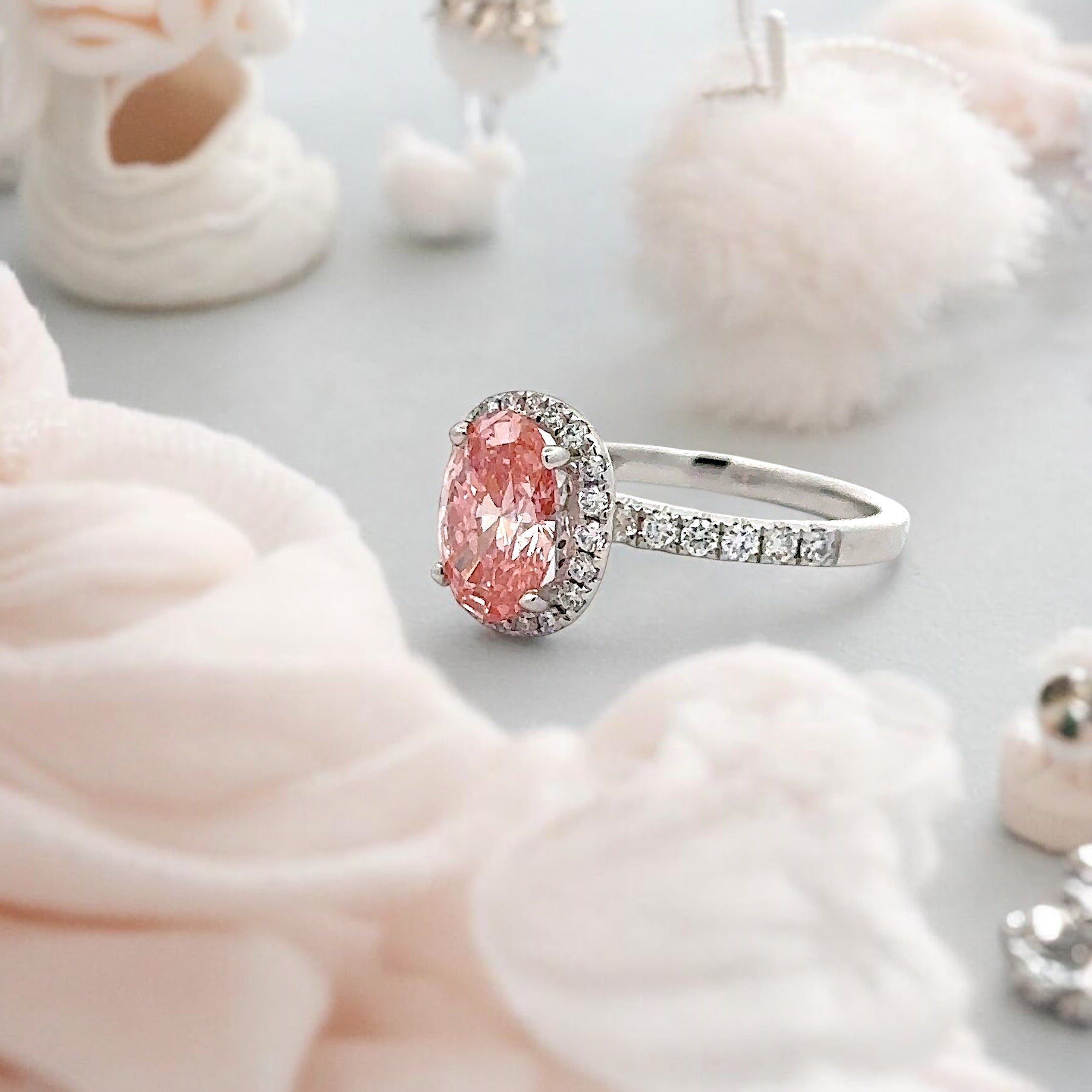 18K PINK DIAMOND OVAL CUT CENTRE STONE IN A HALO SETTING IN A 18K DIAMOND ACCENTED BAND – 2.55 CTW