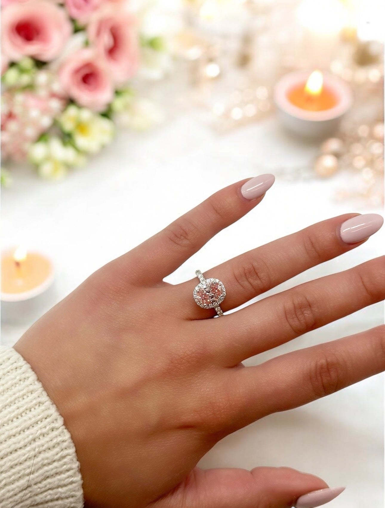 18K PINK DIAMOND OVAL CUT CENTRE STONE IN A HALO SETTING IN A 18K DIAMOND ACCENTED BAND – 2.55 CTW