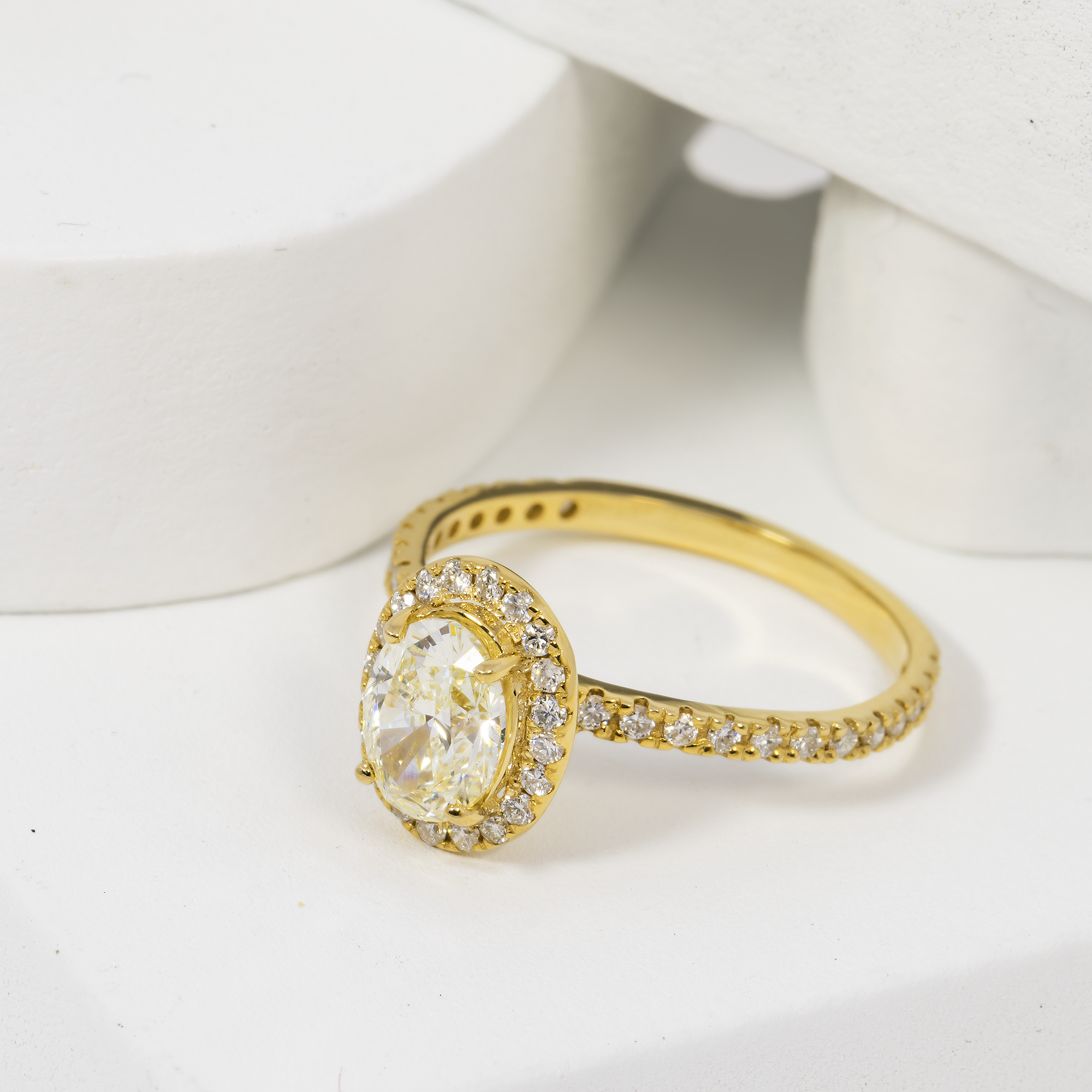 14K OVAL CUT CENTRE STONE IN A HALO SETTING IN A 14K DIAMOND ACCENTED BAND – 1.9 CTW
